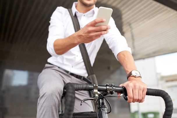 man with smartphone and fixed gear bike on street - Valokuva, kuva