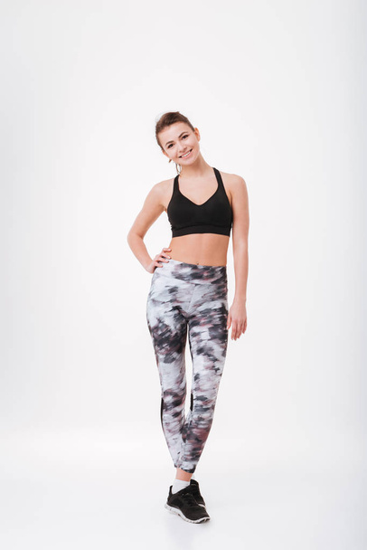 Cheerful young fitness lady standing isolated - Zdjęcie, obraz