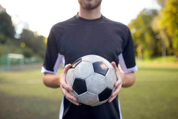 close up of soccer player with football on field - Foto, imagen