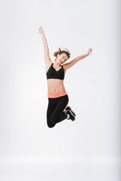 Happy young fitness woman jumping - Foto, Imagem