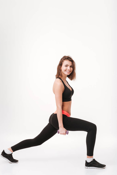 Happy young fitness lady make exercises with dumbbells - Valokuva, kuva