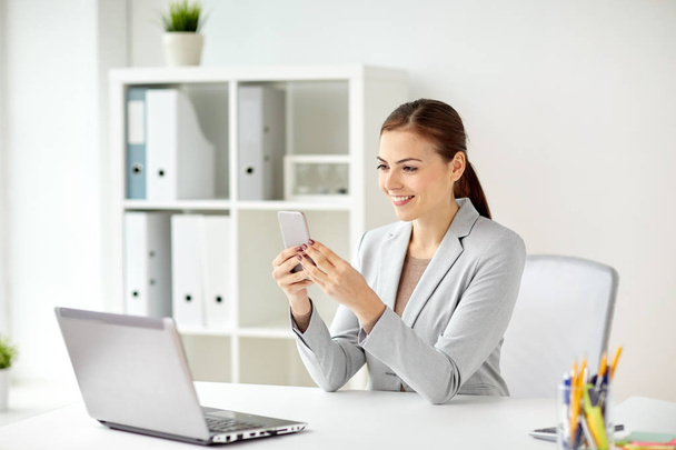 businesswoman with smartphone at office - Photo, Image