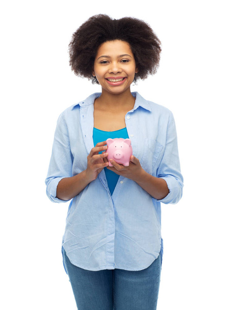 happy afro american young woman with piggy bank - Фото, зображення