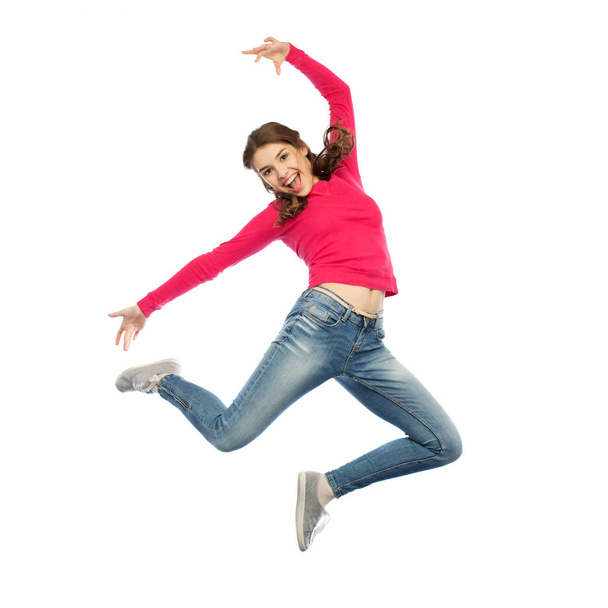 happy young woman jumping in air or dancing - 写真・画像