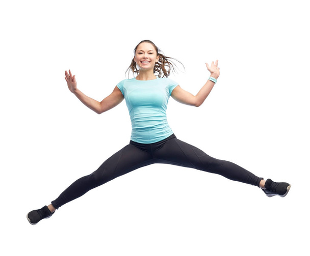 happy smiling sporty young woman jumping in air - Foto, Imagem