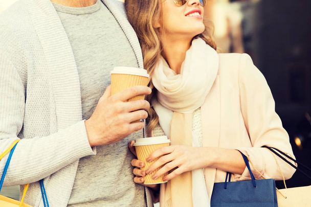 close up of couple with shopping bags and coffee - Φωτογραφία, εικόνα