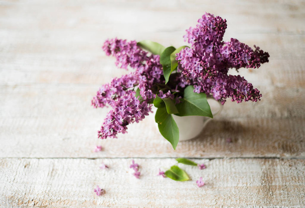 Purple lilac bouquet laid on wooden table. Studio shot. - Foto, immagini