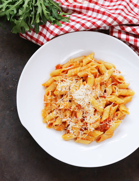 penne pasta with tomato sauce in a white plate - Zdjęcie, obraz