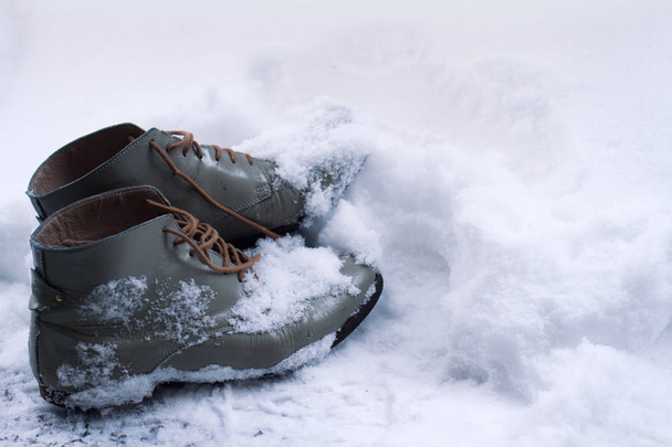 vintage leather shoes covered in snow  - Photo, image