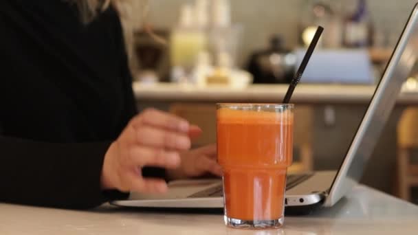 Woman drinking fresh carrot juice - Кадры, видео