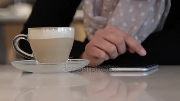 Using smartphone on coffeshop table - Footage, Video