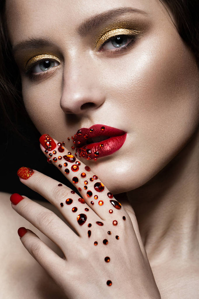 Beautiful girl with evening make-up, red lips in rhinestones and design manicure nails. beauty face. - Fotografie, Obrázek