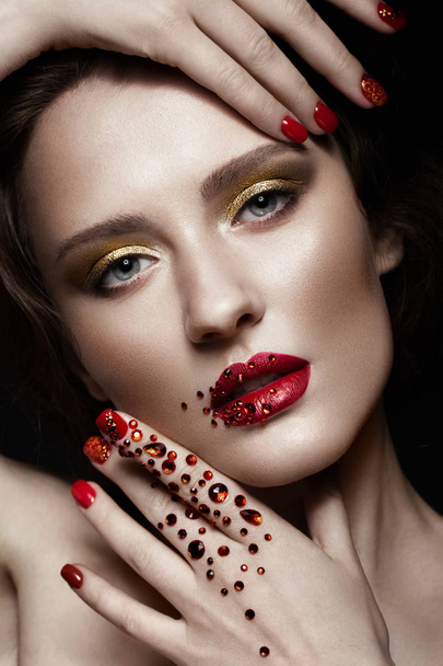 Beautiful girl with evening make-up, red lips in rhinestones and design manicure nails. beauty face. - Φωτογραφία, εικόνα