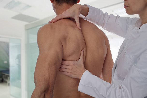 Chiropractic, osteopathy, manual therapy, acupressure. Therapist doing healing treatment on man's back. Alternative medicine, pain relief concept. Rehabilitation after Back Injury, Physical therapy. - Foto, Bild