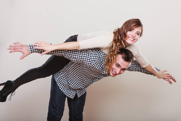 Woman riding piggyback on man. Happy couple. - Fotó, kép