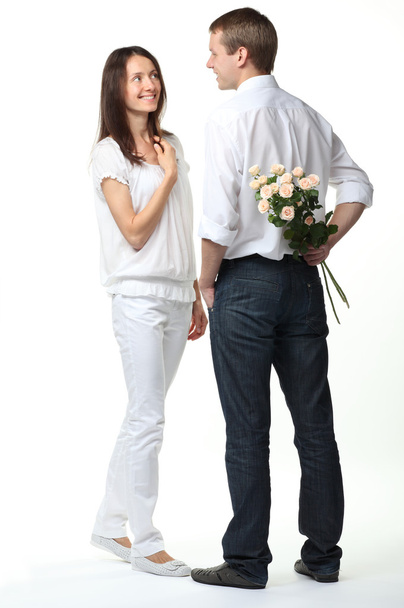 Romantic date: guy presenting flowers to young lady - Photo, image