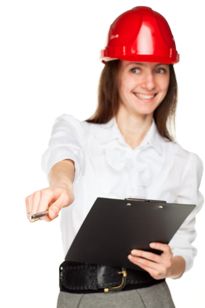 Smiling young woman in red hard hat - Foto, immagini