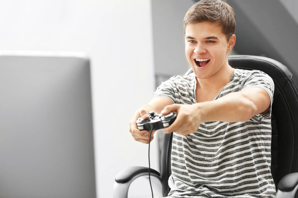 Teenager playing videogame - Фото, зображення