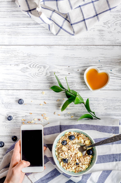 Breakfast concept with flowers on wooden background top view - Foto, Bild