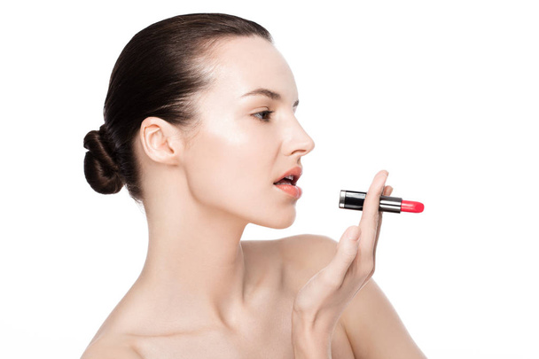 Beautiful model girl holding lipstick tube makeup - Photo, image