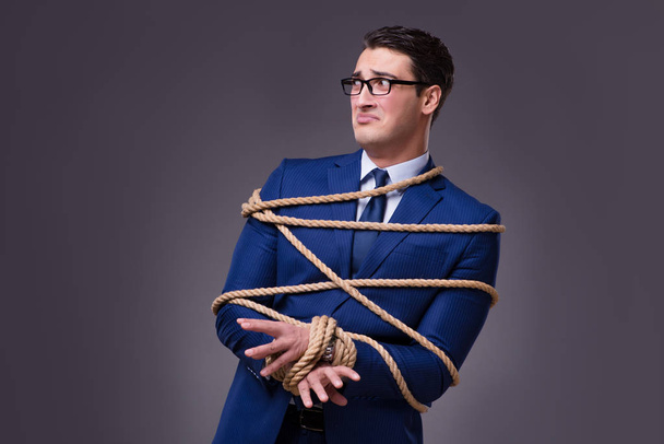 Businessman tied up with rope - Foto, Bild