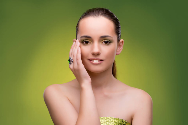 Young woman in beauty concept on green background - Photo, Image