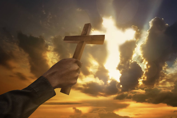 Man hand holding wood cross or religion symbol shape - Photo, Image