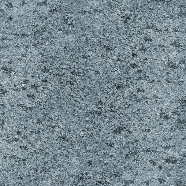 Textuur van de monochromatische van graniet oppervlak. Gedetailleerde foto van de behandelde glanzende granieten steen, die wordt gebruikt als tegels voor muren en vloeren - Foto, afbeelding