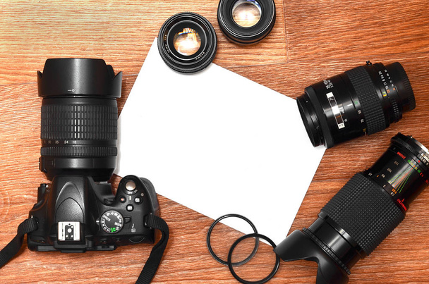 Complete kit for modern digital SLR camera and blank sheet of paper for copyspace. The concept for learning photography. Cover for photo exhibitions, online photo lessons and tutorials - Photo, Image