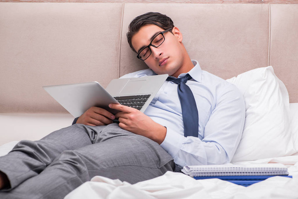 Businessman working in the bed at home - Photo, image