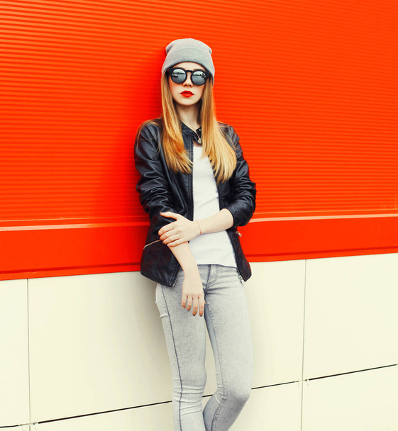 Fashion blonde woman model wearing a sunglasses, hat over red ba - Photo, image