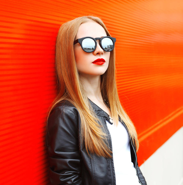 Fashion portrait woman wearing a rock black jacket and sunglasse - Photo, Image