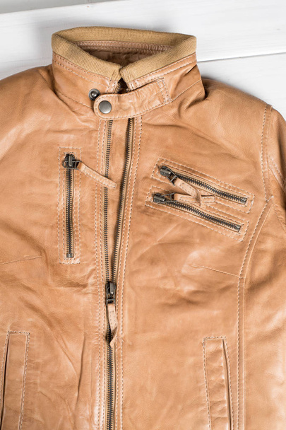 Light brown leather jacket. Beige color leather jacket on hanger.  - Zdjęcie, obraz