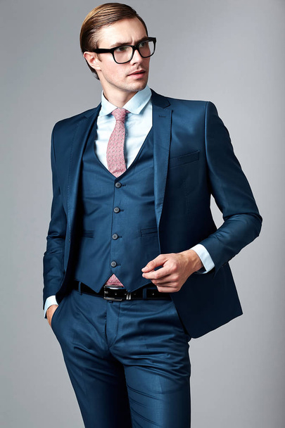  handsome businessman male model in blue suit  posing in studio - Foto, Bild