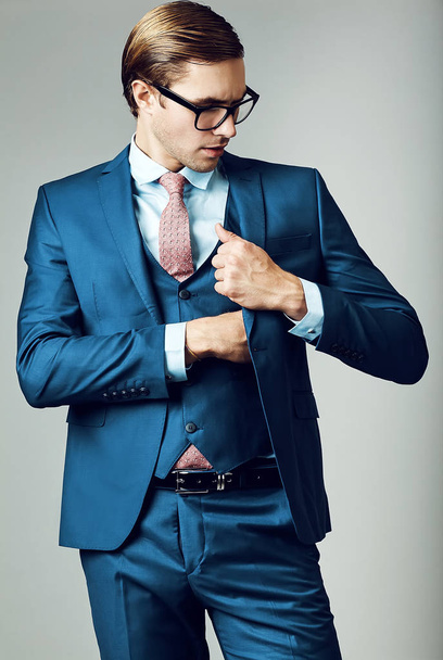  handsome businessman male model in blue suit  posing in studio - Foto, Imagen