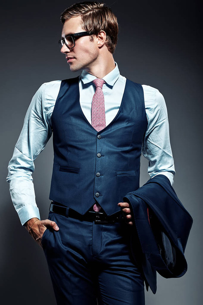  handsome businessman male model in blue suit  posing in studio - Fotografie, Obrázek