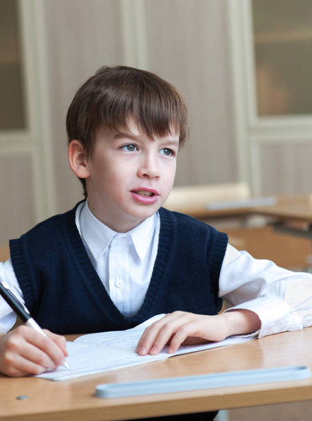 Diligent student sitting at desk, classroom - Fotoğraf, Görsel