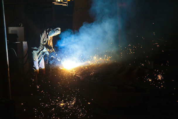 Welder brews metal sparks fly - Photo, Image