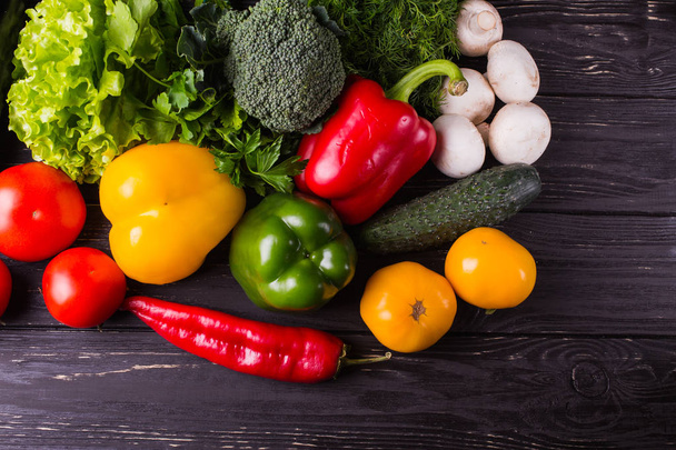 Different organic vegetables on a wooden background. Healthy eat - Fotografie, Obrázek
