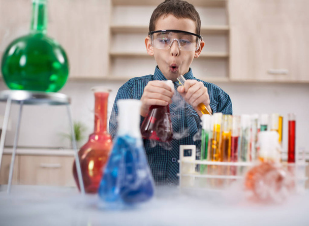 funny scientist boy working in a laboratory - Photo, image