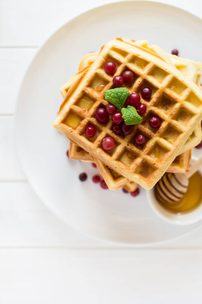 Belgian waffles with honey and cranberries - Фото, зображення