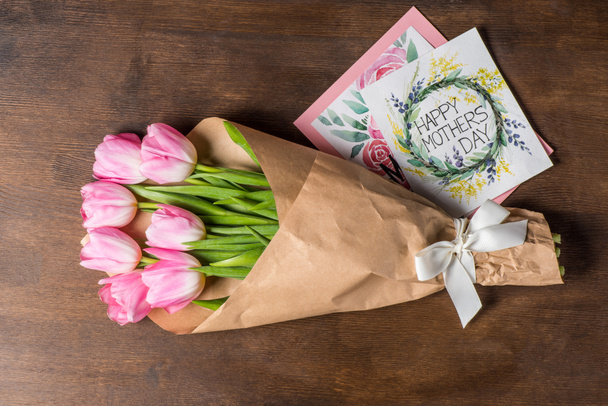 pink tulips bouquet and postcards - Photo, Image
