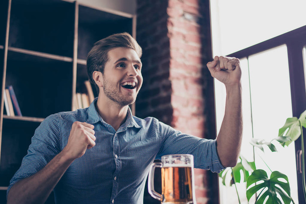 Young excited happy man watching footbal with beer - Photo, image
