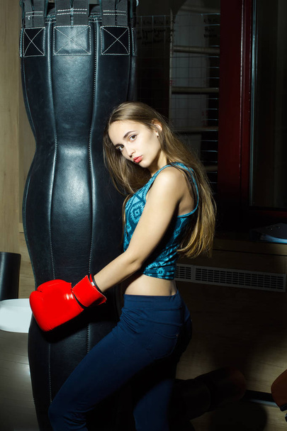 Pretty girl boxer punching - Фото, изображение