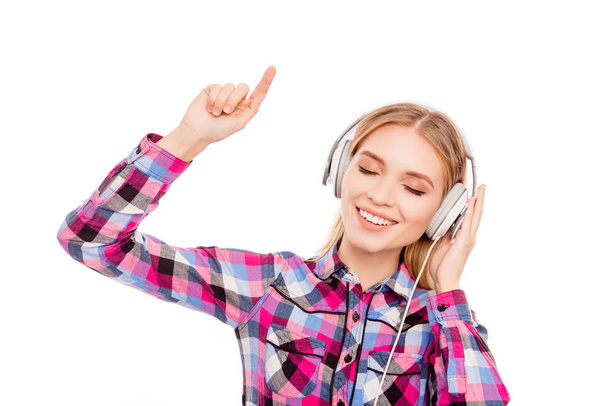 Happy music lover listening music in headphones and dancing - Photo, image