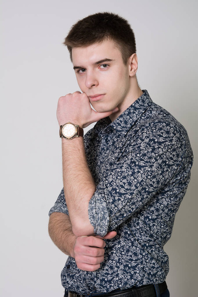 Portrait of a thoughtful young man wearing a shirt - Foto, Bild