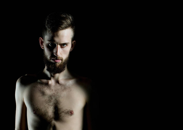 slim bearded man with thin bare torso isolated on black - Foto, Bild