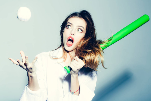 pretty sexy woman with long hair holds green baseball bat - Foto, afbeelding