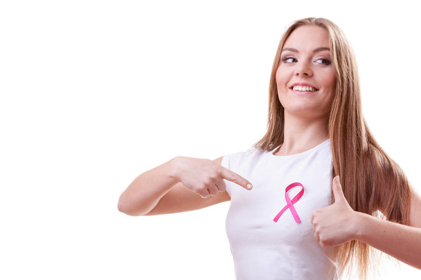woman pink cancer ribbon on chest making thumb up - Foto, afbeelding