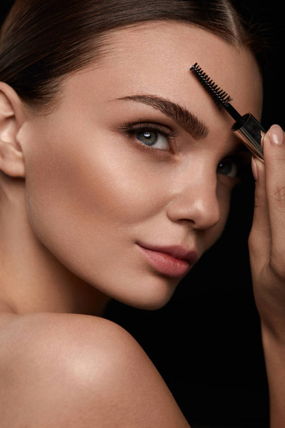Woman Face With Beautiful Eyebrows And Professional Makeup - 写真・画像